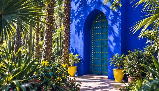 A blue garden doorway framed by palms and plants